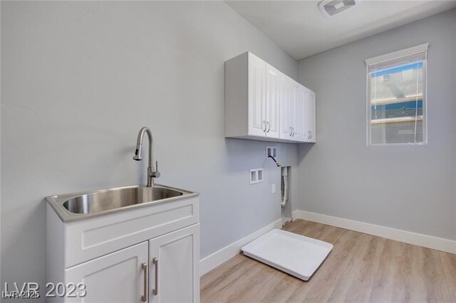 10342 Kesington Dr, Las Vegas, NV 89135 - laundry area with light wood-style floors, cabinet space, and hookup for a washing machine