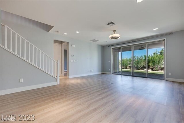 10342 Kesington Dr, Las Vegas, NV 89135 - unfurnished living room featuring recessed lighting, stairway, and wood finished floors