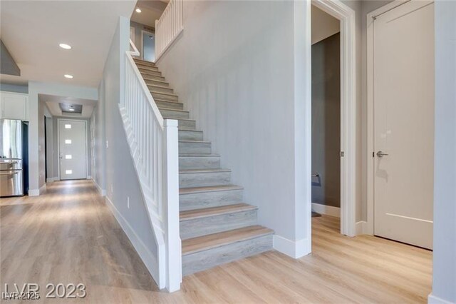 10342 Kesington Dr, Las Vegas, NV 89135 - stairs with wood finished floors and recessed lighting