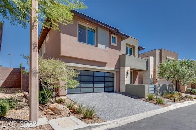 10342 Kesington Dr, Las Vegas, NV 89135 - view of front of property featuring stucco siding, a garage, and decorative driveway