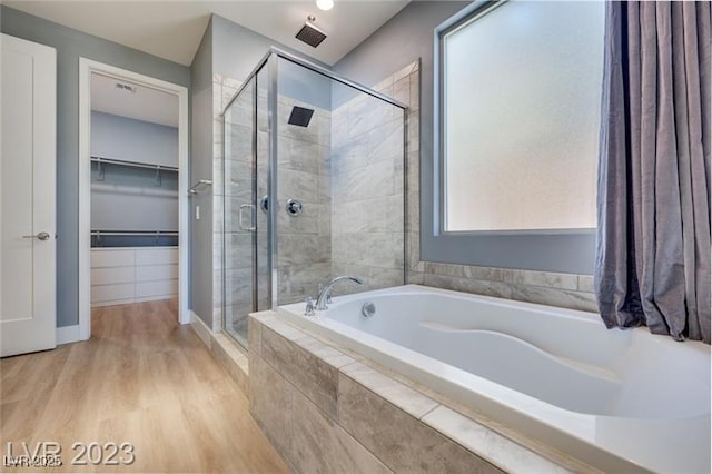 10342 Kesington Dr, Las Vegas, NV 89135 - full bath featuring a shower stall, a bath, wood finished floors, and a walk in closet