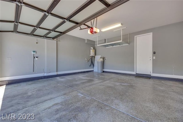 10342 Kesington Dr, Las Vegas, NV 89135 - garage featuring a garage door opener and baseboards