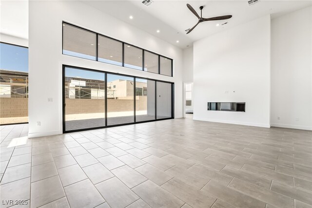 10919 Vista Altura Ave, Las Vegas, NV 89135 - unfurnished living room with a ceiling fan, recessed lighting, and a towering ceiling