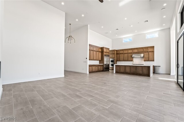 10919 Vista Altura Ave, Las Vegas, NV 89135 - unfurnished living room with a high ceiling and recessed lighting