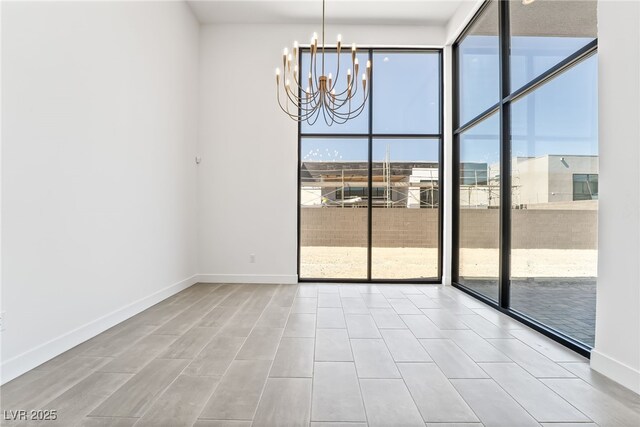 10919 Vista Altura Ave, Las Vegas, NV 89135 - spare room featuring a chandelier and floor to ceiling windows