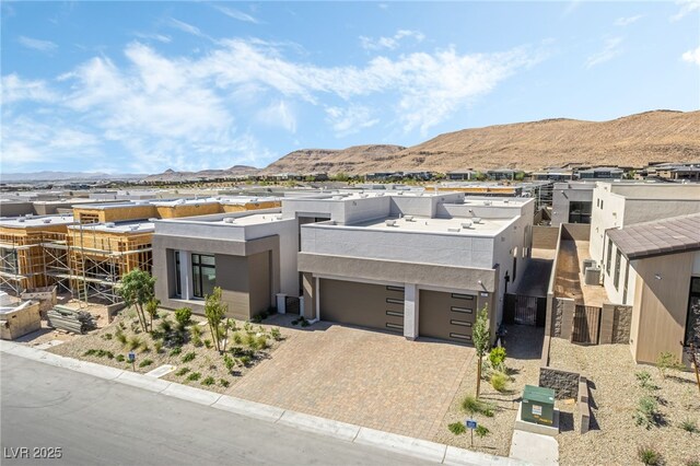 10919 Vista Altura Ave, Las Vegas, NV 89135 - view of front of property featuring stucco siding, driveway, a mountain view, and an attached garage