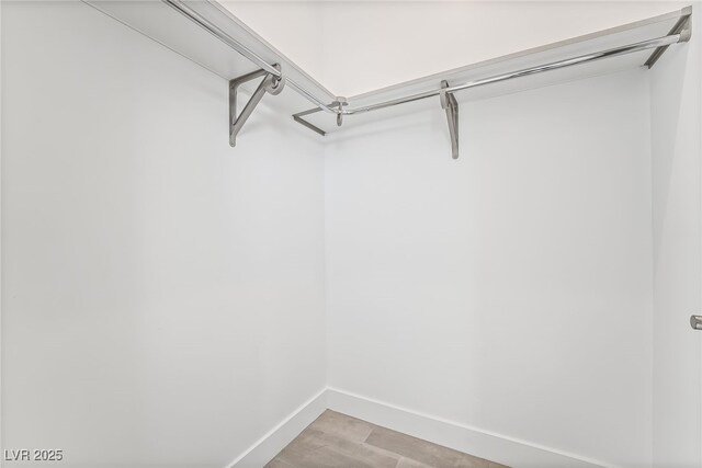 10919 Vista Altura Ave, Las Vegas, NV 89135 - walk in closet with light wood-style floors