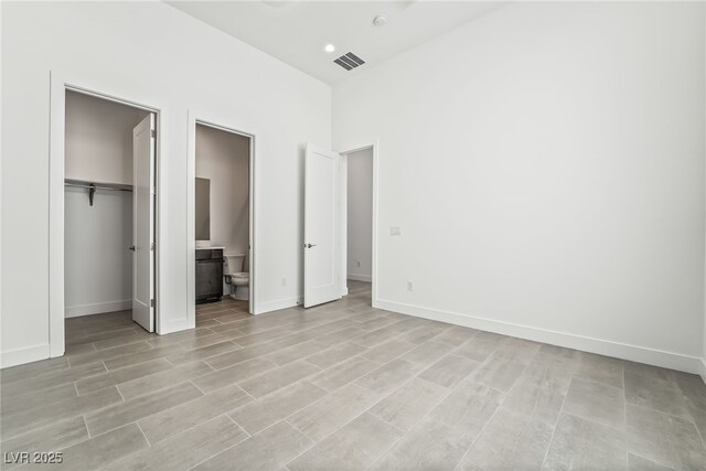 10919 Vista Altura Ave, Las Vegas, NV 89135 - unfurnished bedroom with a spacious closet, a closet, connected bathroom, and light wood finished floors