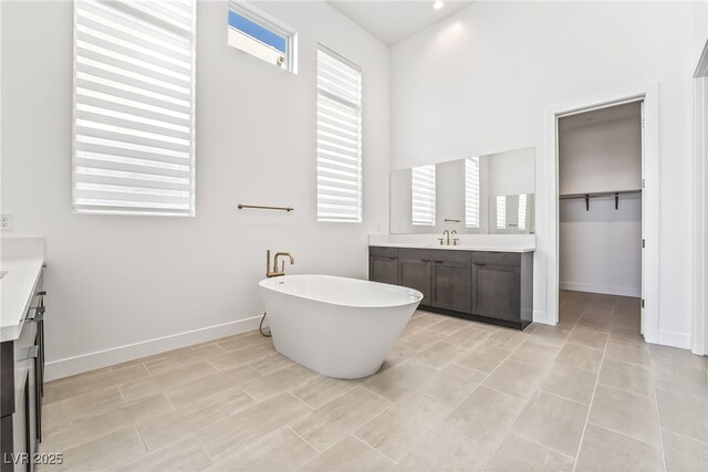 10919 Vista Altura Ave, Las Vegas, NV 89135 - full bath with two vanities, a freestanding tub, and a towering ceiling