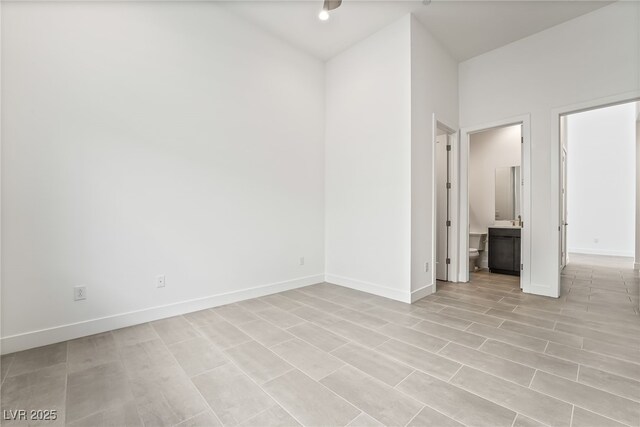 10919 Vista Altura Ave, Las Vegas, NV 89135 - unfurnished bedroom featuring baseboards and ensuite bathroom