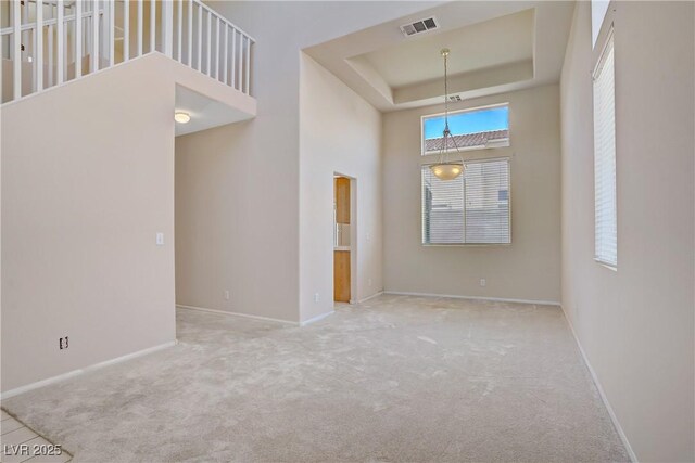 9451 Natoma Station Pl, Las Vegas, NV 89123 - spare room featuring carpet, a towering ceiling, and a tray ceiling