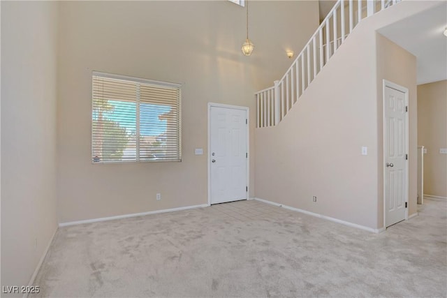 9451 Natoma Station Pl, Las Vegas, NV 89123 - foyer featuring carpet flooring, a high ceiling, and stairway