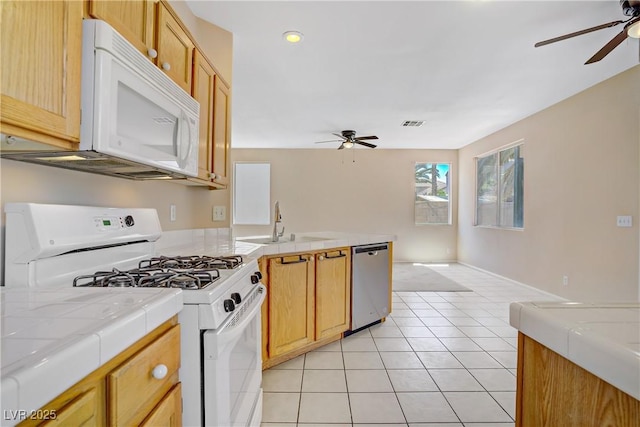 9451 Natoma Station Pl, Las Vegas, NV 89123 - kitchen featuring white appliances, a ceiling fan, tile countertops, light tile patterned floors, and recessed lighting