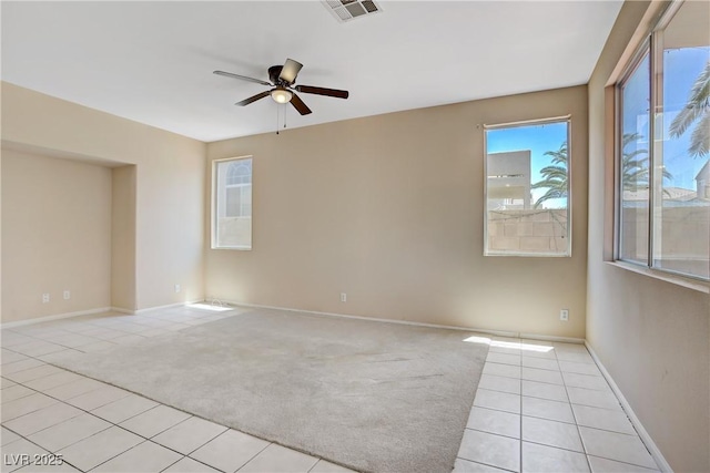 9451 Natoma Station Pl, Las Vegas, NV 89123 - empty room featuring light colored carpet, a ceiling fan, and light tile patterned flooring
