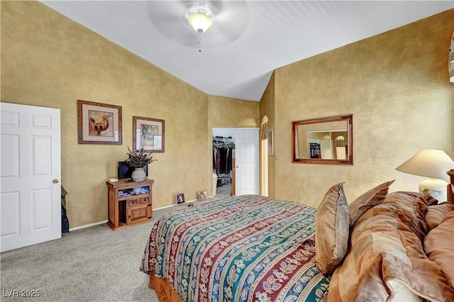 5933 Perfect View St, Las Vegas, NV 89130 - carpeted bedroom with a spacious closet, a ceiling fan, a textured wall, and high vaulted ceiling