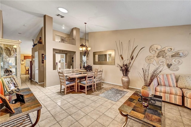 5933 Perfect View St, Las Vegas, NV 89130 - dining area with a chandelier, light tile patterned flooring, and vaulted ceiling