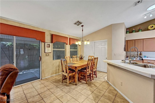 5933 Perfect View St, Las Vegas, NV 89130 - dining room featuring light tile patterned floors, vaulted ceiling, and a chandelier