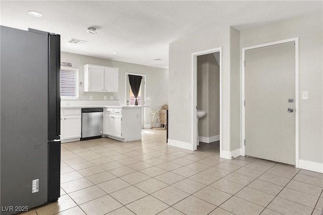 5200 Paradise Skies Ave, Las Vegas, NV 89156 - kitchen with freestanding refrigerator, dishwasher, light countertops, white cabinets, and light tile patterned flooring