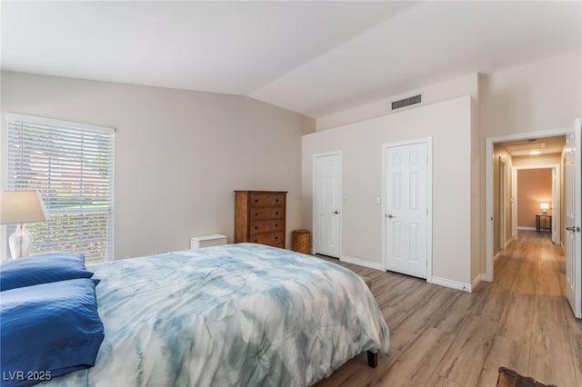 4909 Desert Poppy Dr, Las Vegas, NV 89130 - bedroom with lofted ceiling and light wood-type flooring