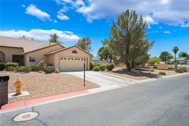 4909 Desert Poppy Dr, Las Vegas, NV 89130 - view of front of property with stucco siding, an attached garage, concrete driveway, a tiled roof, and a chimney
