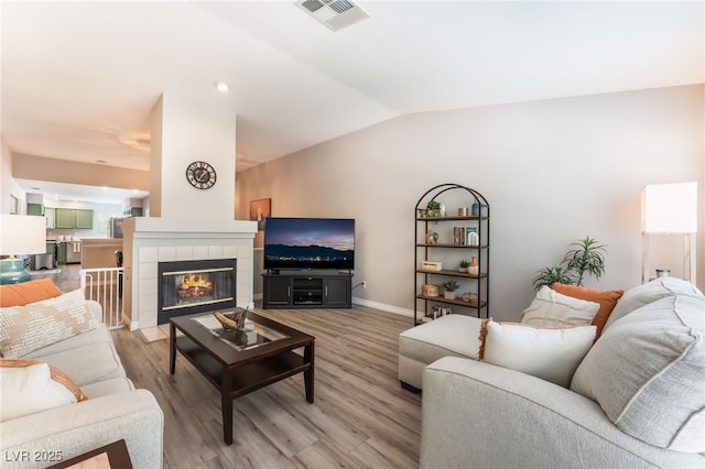 4909 Desert Poppy Dr, Las Vegas, NV 89130 - living area featuring light wood-style flooring, lofted ceiling, and a fireplace