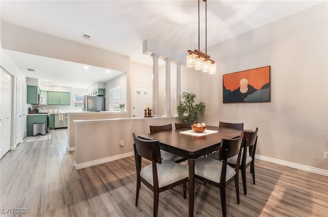 4909 Desert Poppy Dr, Las Vegas, NV 89130 - dining space with light wood-style floors and decorative columns