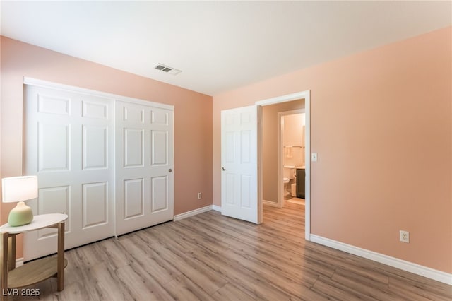 4909 Desert Poppy Dr, Las Vegas, NV 89130 - unfurnished bedroom featuring light wood finished floors and a closet