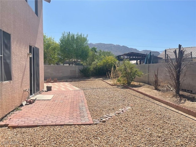 1278 N Sloan Ln, Las Vegas, NV 89110 - fenced backyard with a patio and a mountain view