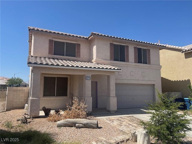 1278 N Sloan Ln, Las Vegas, NV 89110 - view of front of home featuring an attached garage, a tiled roof, and stucco siding
