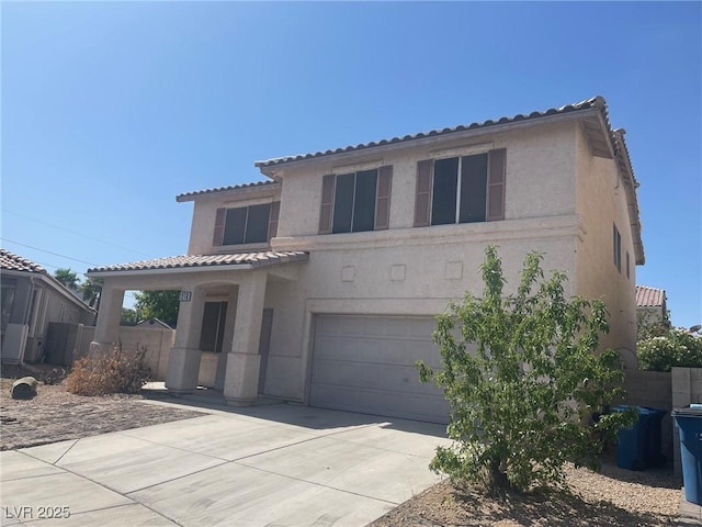 1278 N Sloan Ln, Las Vegas, NV 89110 - mediterranean / spanish house with an attached garage, stucco siding, a tiled roof, and driveway