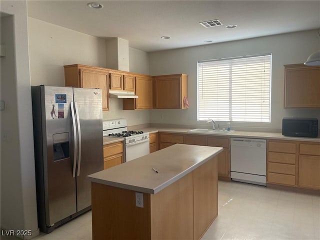 1278 N Sloan Ln, Las Vegas, NV 89110 - kitchen with white appliances, under cabinet range hood, light countertops, a center island, and recessed lighting