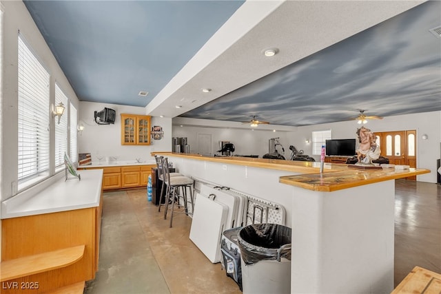 825 W Ryan Ave, Overton, NV 89040 - kitchen featuring concrete flooring, a ceiling fan, a kitchen breakfast bar, and plenty of natural light