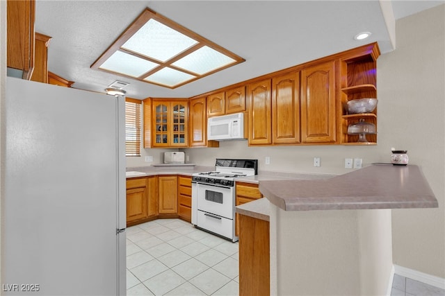 825 W Ryan Ave, Overton, NV 89040 - kitchen with white appliances, a peninsula, light tile patterned flooring, open shelves, and glass insert cabinets
