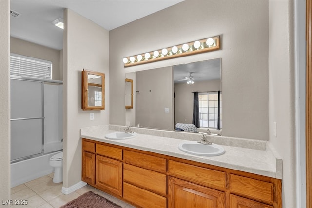 825 W Ryan Ave, Overton, NV 89040 - ensuite bathroom with double vanity, tile patterned flooring, a ceiling fan, and shower / bath combination with glass door