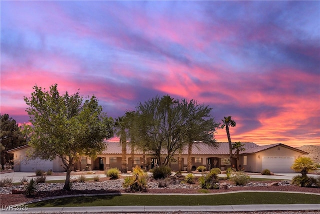 825 W Ryan Ave, Overton, NV 89040 - ranch-style house featuring concrete driveway, a tile roof, a garage, and stucco siding
