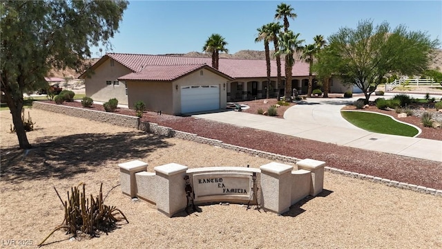 825 W Ryan Ave, Overton, NV 89040 - ranch-style home featuring stucco siding, driveway, a tile roof, and a garage