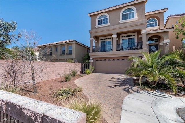 6705 Philharmonic Ave, Las Vegas, NV 89139 - mediterranean / spanish-style home featuring stucco siding, decorative driveway, a balcony, a garage, and a tile roof