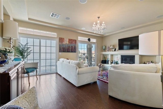 6705 Philharmonic Ave, Las Vegas, NV 89139 - living room with dark wood-style flooring, a chandelier, and a glass covered fireplace