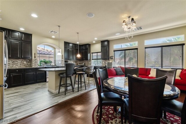 6705 Philharmonic Ave, Las Vegas, NV 89139 - dining area featuring healthy amount of natural light, light wood-style floors, recessed lighting, and a chandelier