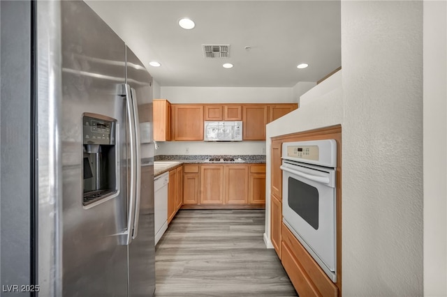 23 E Agate Ave Unit 308, Las Vegas, NV 89123 - kitchen with white appliances, light wood-style floors, recessed lighting, and light stone countertops