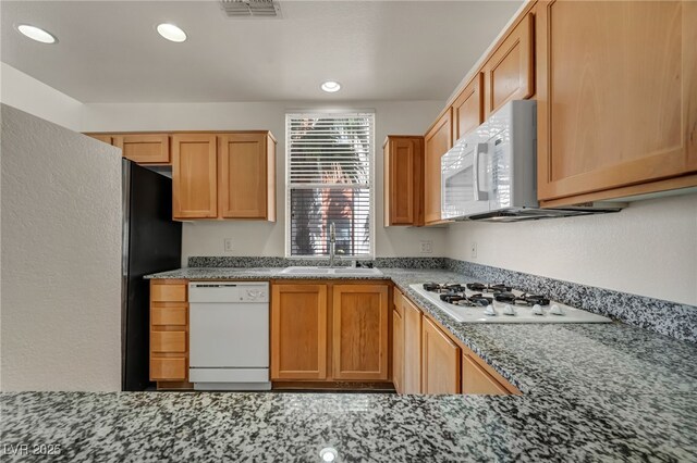 23 E Agate Ave Unit 308, Las Vegas, NV 89123 - kitchen featuring white appliances, recessed lighting, and stone countertops