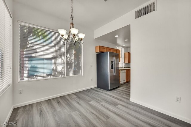 23 E Agate Ave Unit 308, Las Vegas, NV 89123 - unfurnished dining area with a chandelier, light wood finished floors, and recessed lighting