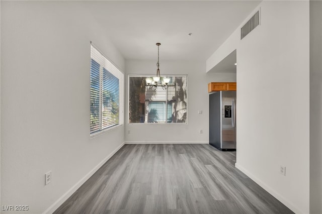 23 E Agate Ave Unit 308, Las Vegas, NV 89123 - unfurnished dining area with a chandelier and wood finished floors