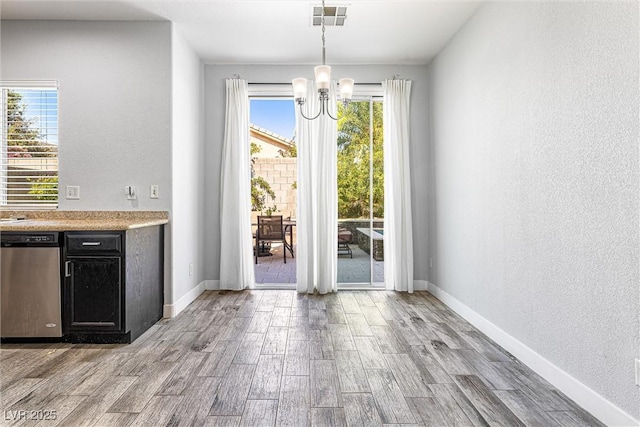 3257 Rushing Waters Pl, Las Vegas, NV 89135 - unfurnished dining area with a chandelier, wood finished floors, and a textured wall
