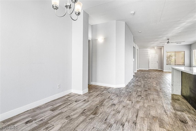 3257 Rushing Waters Pl, Las Vegas, NV 89135 - unfurnished living room featuring wood finished floors, a chandelier, and a ceiling fan