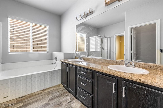 3257 Rushing Waters Pl, Las Vegas, NV 89135 - bathroom with double vanity, a stall shower, a bath, and wood finished floors