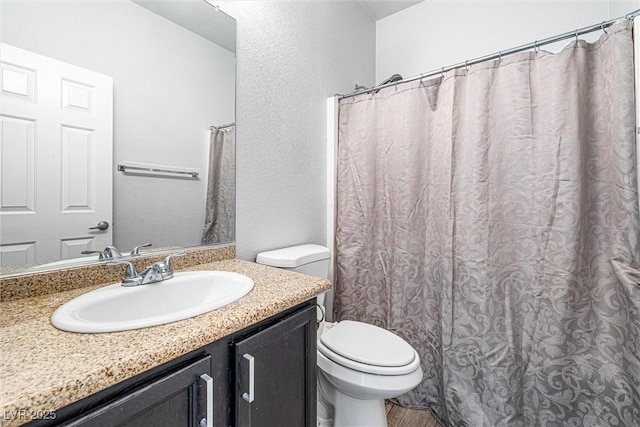 3257 Rushing Waters Pl, Las Vegas, NV 89135 - full bathroom featuring vanity, a textured wall, and wood finished floors