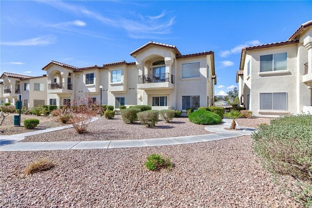 4820 Grey Wolf Ln Unit 101, Las Vegas, NV 89149 - mediterranean / spanish home with stucco siding, a residential view, a tile roof, and a balcony