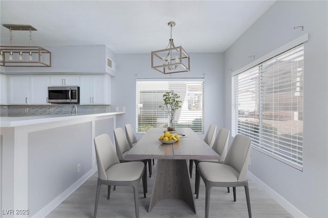 4820 Grey Wolf Ln Unit 101, Las Vegas, NV 89149 - dining space featuring a chandelier and baseboards