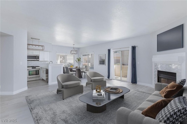 4820 Grey Wolf Ln Unit 101, Las Vegas, NV 89149 - living room with light wood finished floors and a tile fireplace